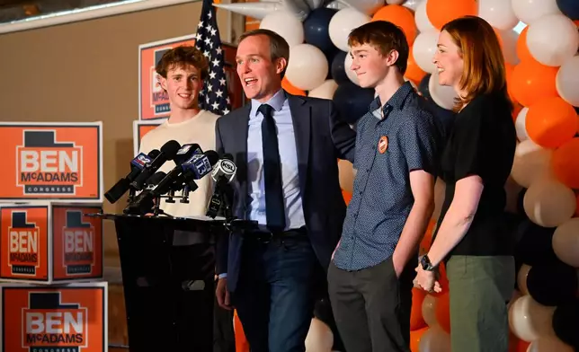 Democratic congressional candidate Ben McAdams speaks between family members James, Isaac and Julie during a watch party for Utah's primary election on Tuesday, June 23, 2026, in Salt Lake City. (AP Photo/Alex Goodlett)