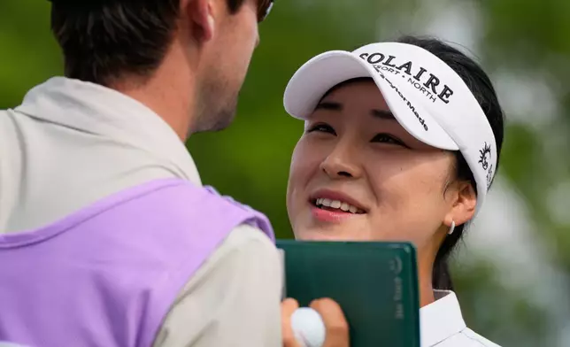 Ina Yoon, of South Korea, right, talks with her caddie on the ninth hole during the second round of the Women's PGA Championship golf tournament, Friday, June 26, 2026, in Chaska, Minn. (AP Photo/Chris Carlson)