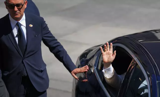 Pope Leo XIV waves as he exits the Spanish parliament in Madrid, Spain, Monday, June 8, 2026. (AP Photo/Manu Fernandez)