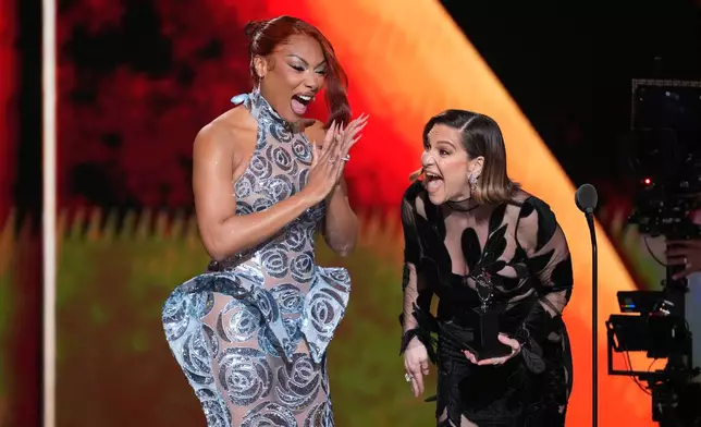 Megan Thee Stallion, left, presents the award for best performance by an actress in a featured role in a musical to Shoshana Bean for "The Lost Boys" during the 79th Tony Awards on Sunday, June 7, 2026, at Radio City Music Hall in New York. (Photo by Charles Sykes/Invision/AP)