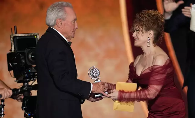 Bernadette Peters, left, presents the award for best musical to Lorne Michaels for "Schmigadoon!" during the 79th Tony Awards on Sunday, June 7, 2026, at Radio City Music Hall in New York. (Photo by Charles Sykes/Invision/AP)