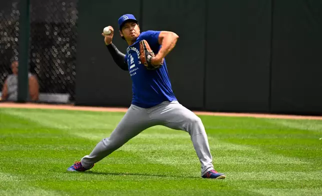 Los Angeles Dodgers two-way player Shohei Ohtani, from Japan, warms up before a baseball game against the Chicago White Sox, Saturday, June 13, 2026, in Chicago. (AP Photo/Matt Marton)