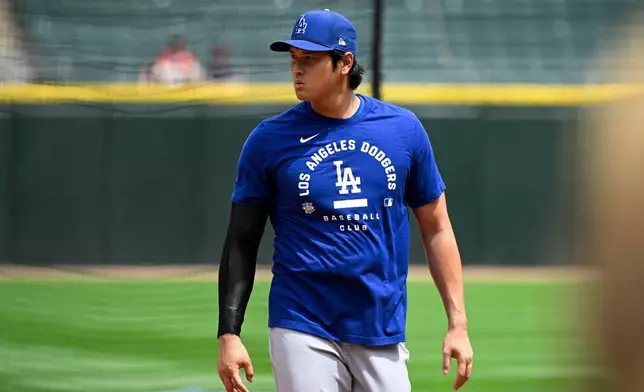 Los Angeles Dodgers two-way player Shohei Ohtani, from Japan, during warmups before a baseball game against the Chicago White Sox, Saturday, June 13, 2026, in Chicago. (AP Photo/Matt Marton)