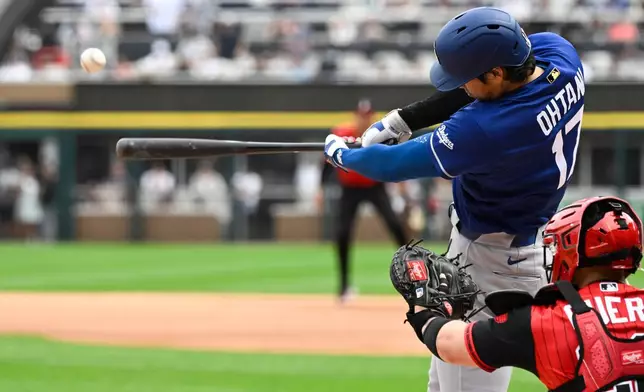 Los Angeles Dodgers' Shohei Ohtani (17), of Japan, hits a home run during the first inning of a baseball game against the Chicago White Sox, Saturday, June 13, 2026, in Chicago. (AP Photo/Matt Marton)