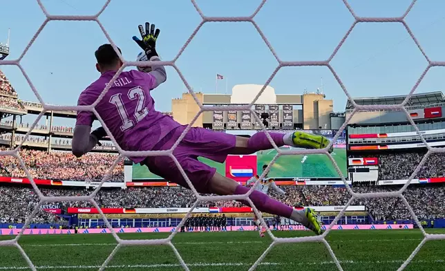 Paraguay goalkeeper Orlando Gill (12) makes a save from Germany's Kai Havertz (7) during a penalty shootout during the World Cup round of 32 soccer match between Germany and Paraguay in Foxborough, Mass., near Boston, Monday, June 29, 2026. (AP Photo/Martin Meissner)