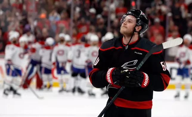 Carolina Hurricanes' Eric Robinson celebrates following Game 5 of the Eastern Conference finals NHL hockey Stanley Cup playoff series against the Montreal Canadiens in Raleigh, N.C., Friday, May 29, 2026. (AP Photo/Karl DeBlaker)
