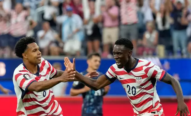 United States' Folarin Balogun (20) celebrates scoring his side's second goal against Paraguay during the World Cup Group D soccer match in Inglewood, Calif., near Los Angeles, Friday, June 12, 2026. (AP Photo/Andre Penner)