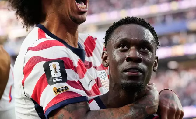 United States' Folarin Balogun (20) celebrates scoring his side's third goal against Paraguay with teamate Chris Richards during the World Cup Group D soccer match in Inglewood, Calif., near Los Angeles, Friday, June 12, 2026. (AP Photo/Andre Penner)