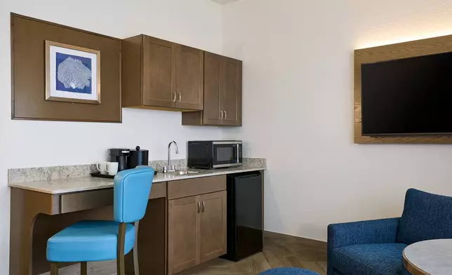 The resort offers 80 Jr. Suites with kitchenettes, and many with beach and bay views. Designed to balance relaxation and productivity, each guest room features architectural details and thoughtful amenities that enhance comfort and convenience, including: • Spacious bathrooms with walk-in showers and ample storage • Conveniently located power outlets, bedside charging stations, and USB-equipped nightstands for multiple devices • Premium bedding featuring cotton-rich linens and plush pillows • High-speed Wi-Fi and a dedicated workspace with a large desk, ergonomic seating, ample lighting, and integrated power connections • 55-inch flat-screen televisions with the Hilton Entertainment Package, including premium cable and movie channels • In-room coffee bar • Strategically placed mirrors, including illuminated vanity mirrors and full-length mirrors