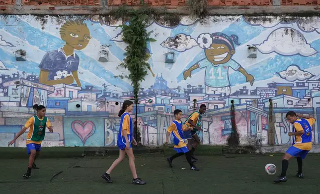 Teenagers attend a soccer training session by the Street Child United Brazil social project in the Complexo da Penha of Rio de Janeiro, Wednesday, June 3, 2026. (AP Photo/Silvia Izquierdo)