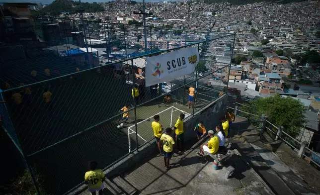 Youths attend soccer training organized by the Street Child United Brazil social project in the Complexo da Penha of Rio de Janeiro, Wednesday, June 3, 2026. (AP Photo/Silvia Izquierdo)