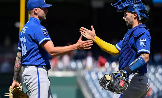 Kansas City Royals closing pitcher Alex Lange, left, is congratulated by Royals catcher Carter Jensen after defeating the Washington Nationals, Wednesday, June 17, 2026, in Washington. (AP Photo/John McDonnell)