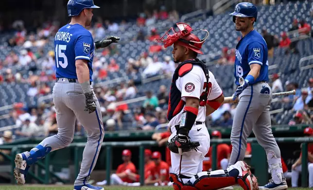 Washington Nationals catcher Keibert Ruiz waits for the next batter as Kansas City Royals' Lane Thomas (15) is greeted at the plate by Royals' Michael Massey at home plate after hitting a solo home run during the third inning of a baseball game, Wednesday, June 17, 2026, in Washington. (AP Photo/John McDonnell)