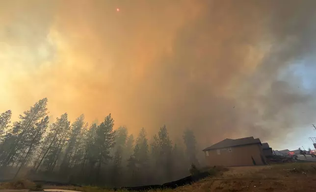 This photo provided by Spokane Fire District 9 shows the Upriver Fire burning northeast of Spokane, Wash., on Tuesday, June 16, 2026. (Robert Gray/Spokane Fire District 9 via AP)