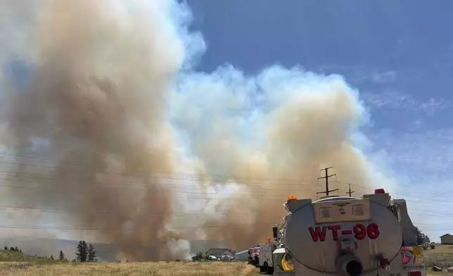 This photo provided by Spokane Fire District 9 shows smoke rising from the Upriver Fire burning northeast of Spokane, Wash., on Tuesday, June 16, 2026. (Robert Gray/Spokane Fire District 9 via AP)