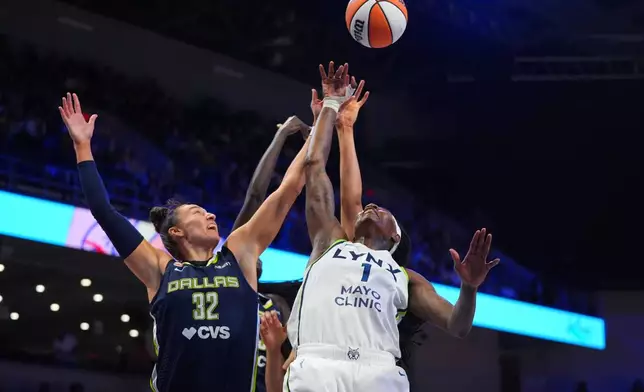 Minnesota Lynx forward Natasha Howard (1), Dallas Wings forward Jessica Shepard (32) and others jump for a rebound during the first half of a WNBA basketball game in Arlington, Texas, Sunday, June 28, 2026. (AP Photo/LM Otero)