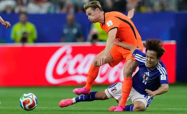 Netherlands' Frenkie de Jong, left, and Japan's Takefusa Kubo fight for the ball during the World Cup Group F soccer match between the Netherlands and Japan in Arlington, Texas, near Dallas, Sunday, June 14, 2026. (AP Photo/Tony Guttierez)