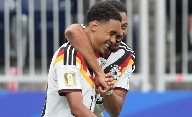 Germany's Felix Nmecha hugs Jamal Musiala after he scored during the World Cup Group E soccer match between Germany and Curacao in Houston, Sunday, June 14, 2026. (AP Photo/Eric Gay)