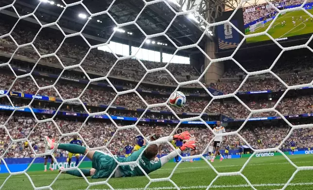 Germany goalkeeper Manuel Neuer (1) is beaten by a shot from Curaçao's Livano Comenencia (8) for the opening goal during the World Cup Group E soccer match between Germany and Curacao in Houston, Sunday, June 14, 2026. (AP Photo/Eric Gay)