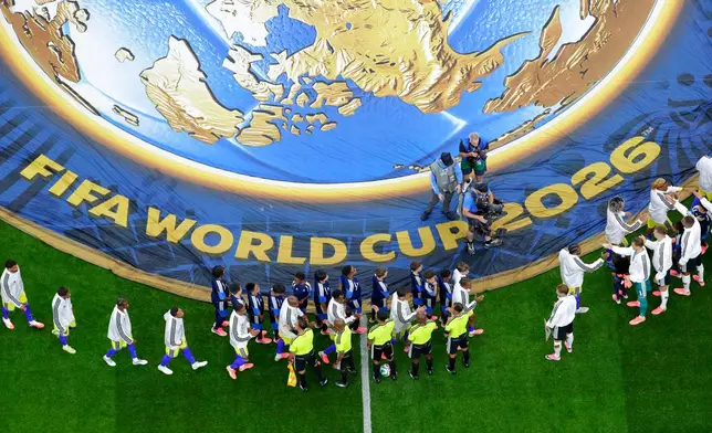 Players greet each other before the start of the World Cup Group E soccer match between Germany and Curacao in Houston, Sunday, June 14, 2026. (AP Photo/Michael Wyke)