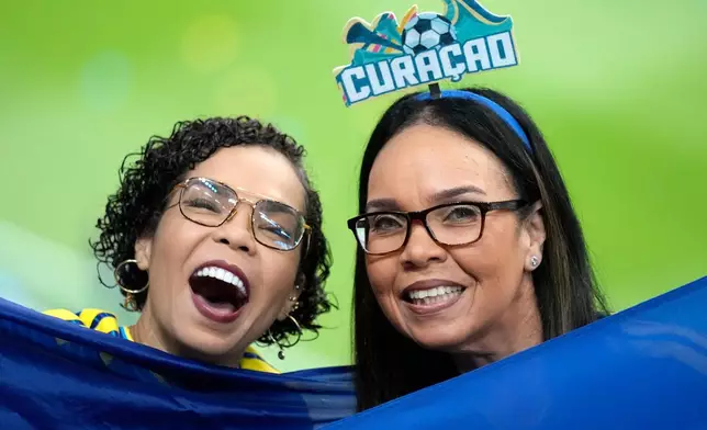 Curacao fans pose before the World Cup Group E soccer match between Germany and Curacao in Houston, Sunday, June 14, 2026. (AP Photo/Eric Smith)