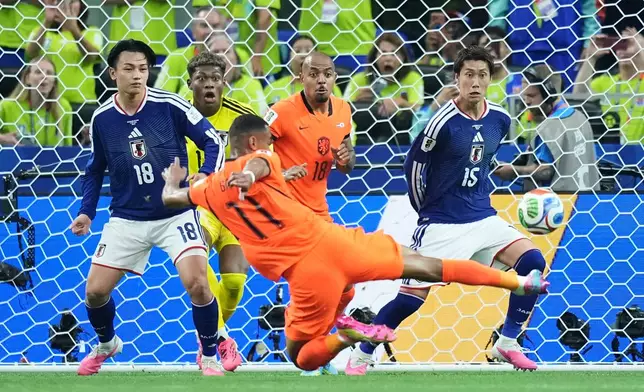 Netherlands' Cody Gakpo (11) kicks the ball during a World Cup Group F soccer match against Japan in Arlington, Texas, near Dallas, Sunday, June 14, 2026. (AP Photo/Julio Cortez)