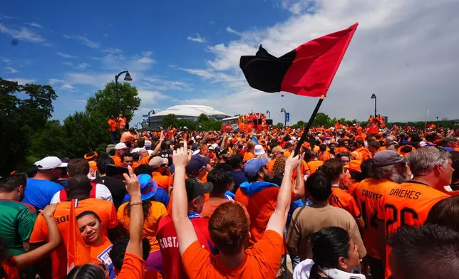 Fans conduct an "Orange Walk" to Dallas Stadium before the World Cup Group F soccer match between Japan and the Netherlands, Sunday, June 14, 2026, in Arlington, Texas. (AP Photo/LM Otero)