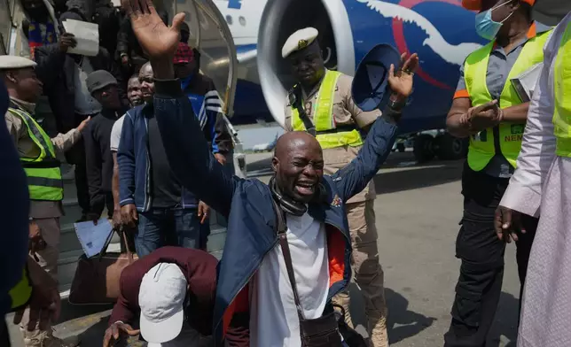 Nigerian nationals repatriated from South Africa, following concerns about unrest, reacts upon arrival at the Murtala Muhammed International Airport in Lagos, Nigeria, Thursday, June 11, 2026. (AP Photo/Sunday Alamba)