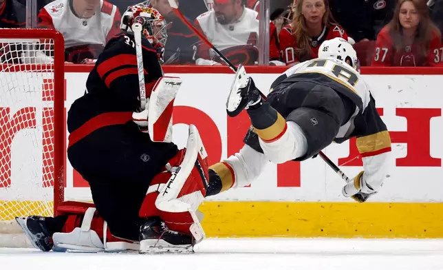 Vegas Golden Knights' Tomas Hertl (48) trips over Carolina Hurricanes goaltender Frederik Andersenn (31) during the second period in Game 1 of the NHL hockey Stanley Cup Final series in Raleigh, N.C., Tuesday, June 2, 2026. (AP Photo/Karl DeBlaker)