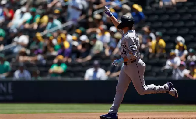 Colorado Rockies' Hunter Goodman rounds the bases after hitting a two-run home run during the first inning of a baseball game against the Athletics, Sunday, June 14, 2026, in Las Vegas. (AP Photo/Caroline Brehman)