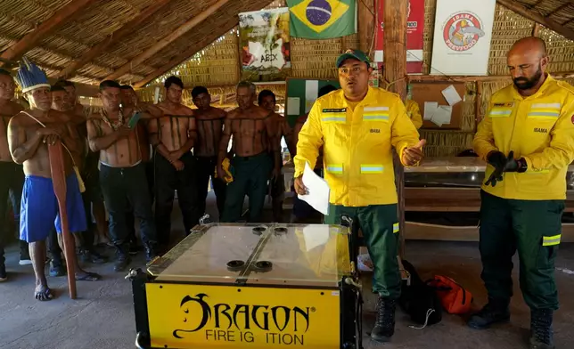 Xerente Indigenous people attend a fire prevention operation along Brazil's environmental protection agency, IBAMA, at the Xerente territory, near Tocantinia, Tocantins state, Brazil, Tuesday, May 19, 2026. (AP Photo/Andre Penner)