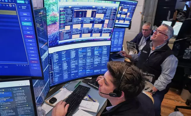 A trio of traders work on the floor of the New York Stock Exchange, Wednesday, June 3, 2026. (AP Photo/Richard Drew)