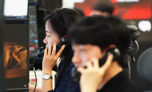 Dealers talk on the phones at a dealing room of Hana Bank in Seoul, South Korea, Thursday, June 11, 2026. (AP Photo/Lee Jin-man)