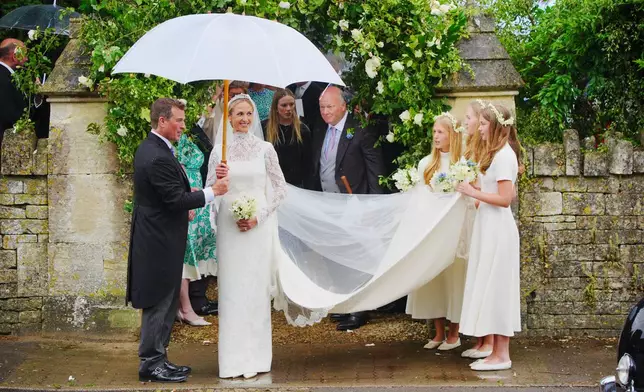 Bride Harriet Sperling and bride groom Peter Phillips, accompanied by bridesmaids after their wedding ceremony at All Saints Church in Kemble, Gloucestershire, England, Saturday, June 6, 2026. (Ben Birchall/PA via AP)