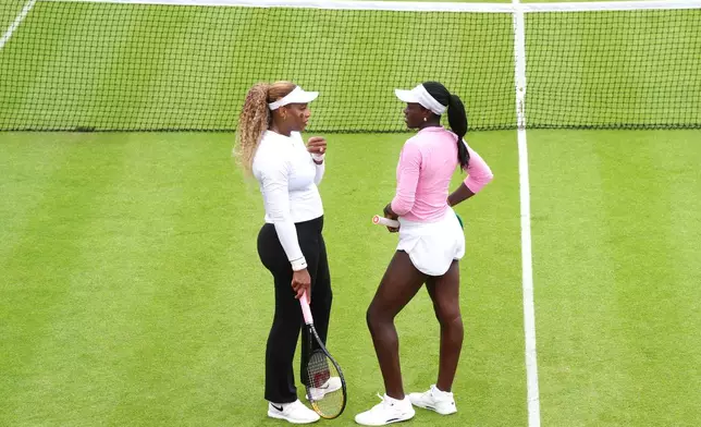 Serena Williams of the US, left, speaks with Canada's Victoria Mboko at The Queen's Club, in London, Sunday June 7, 2026. (Adam Davy/PA via AP)