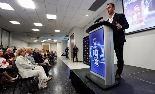 Former Winnipeg Jet and Chicago Blackhawk Jonathan Toews announces his retirement from the NHL as his parents, Andree, Bryan and friends look on during an event at the Jonathan Toews Sportsplex in Winnipeg, Manitoba, Friday, June 19, 2026. (John Woods /The Canadian Press via AP)