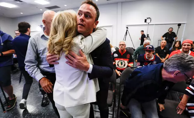 Former Winnipeg Jet and Chicago Blackhawk Jonathan Toews embraces his parents Bryan and Andree before the announces his retirement from the NHL during an event at the Jonathan Toews Sportsplex in Winnipeg, Manitoba, Friday, June 19, 2026. (John Woods /The Canadian Press via AP)