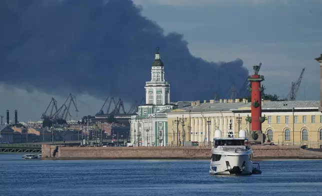 A plumes of black smoke is seen over the port of St. Petersburg, Russia, Wednesday, June 3, 2026, after a Ukrainian drone attack. (AP Photo)
