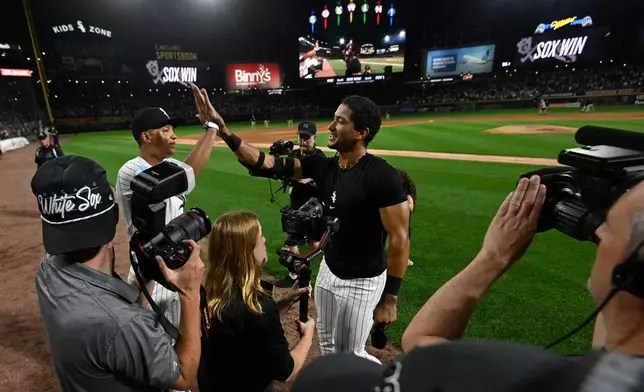 Chicago White Sox's Braden Montgomery, right, celebrates with manager Will Venable, left, after hitting a walk-off two-run home run in the 10th inning of a baseball game to defeat the Atlanta Braves in Chicago, Tuesday, June 9, 2026. (AP Photo/Paul Beaty)