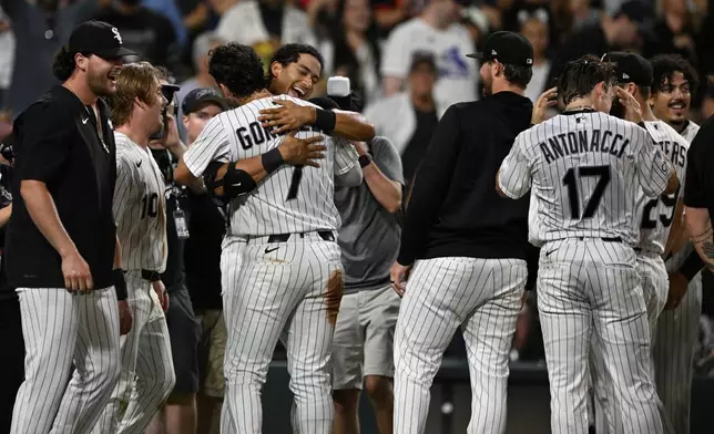 Chicago White Sox's Braden Montgomery, back, hugs teammate Jacob Gonzalez (7) after hitting a walk-off two-run home run in the 10th inning of a baseball game to defeat the Atlanta Braves in Chicago, Tuesday, June 9, 2026. (AP Photo/Paul Beaty)
