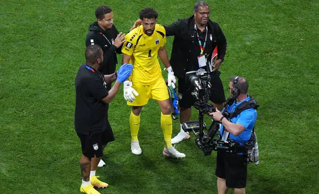 Cape Verde goalkeeper Vozinha (1) is congratulated by team staff as he walks off the pitch following a 0-0 draw during the World Cup Group H soccer match between Spain and Cape Verde in Atlanta, Monday, June 15, 2026. (AP Photo/Jacob Kupferman)