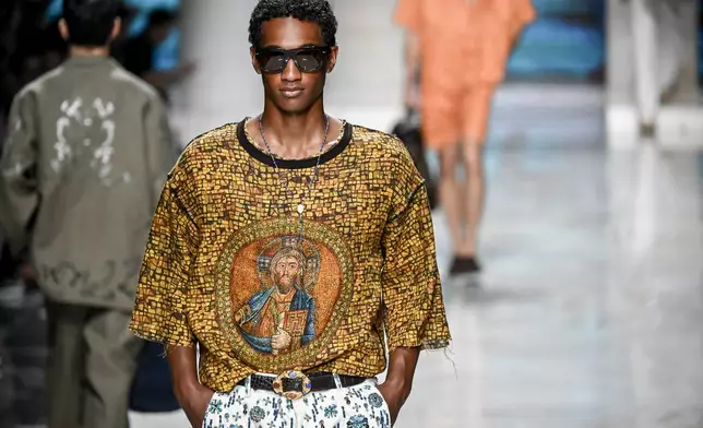 A model wears a creation from the Dolce & Gabbana Spring/Summer 2027 Men's collection presented in Milan, Italy, Saturday, June 20, 2026. (AP Photo/Nicola Marfisi)