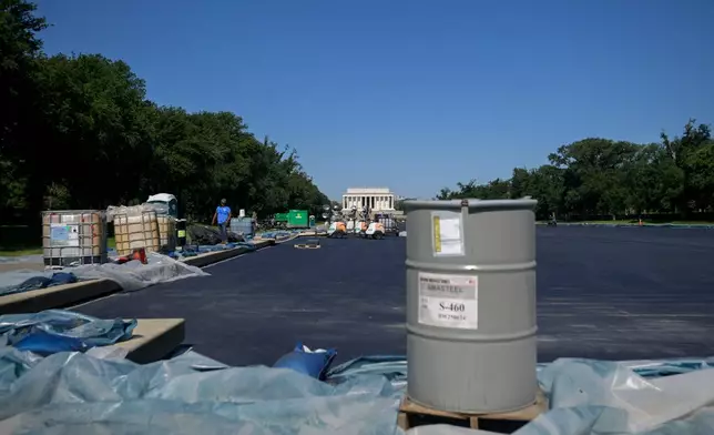 Work continues on the Lincoln Memorial Reflecting Pool, which is covered in a blue protective coating, ahead of the United States 250th anniversary, Thursday, June 4, 2026, in Washington. (AP Photo/Rod Lamkey, Jr.)