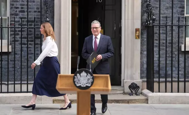 Britain's Prime Minister Keir Starmer and wife Victoria step out to speak to the media outside 10 Downing Street in London, Monday, June 22, 2026.(AP Photo/Kin Cheung)