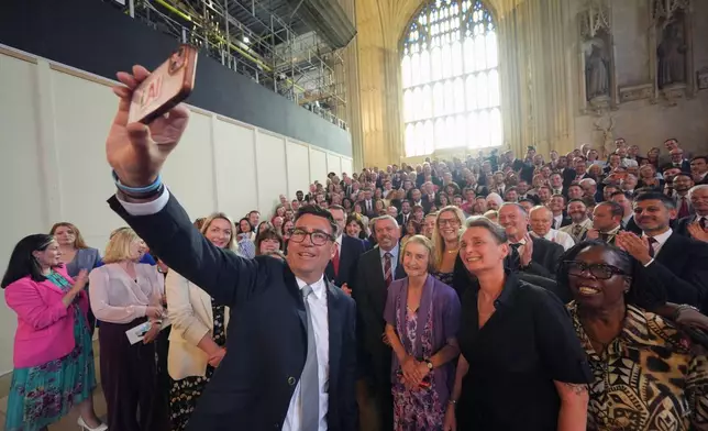 Andy Burnham with colleagues from the Parliamentary Labour Party in Westminster Hall at the Houses of Parliament in central London, as he returns to the House of Commons to take up his seat after winning the Makerfield by-election, Monday June 22, 2026. (Yui Mok/PA via AP)