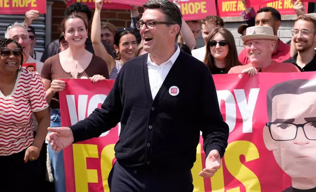 FILE - Labour candidate Andy Burnham gestures, surrounded by supporters at the Stubshaw Cross Community and Sports Club as voting is underway in the Makerfield by-election, in Ashton-in-Makerfield, England, Thursday, June 18, 2026. (Peter Byrne/PA via AP, file)