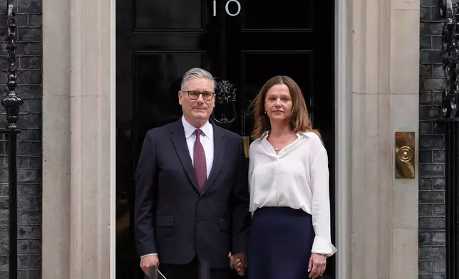 Britain's Prime Minister Keir Starmer and wife Victoria stand in front of 10 Downing Street door after speaking to the media in London, Monday, June 22, 2026.(AP Photo/Kin Cheung)