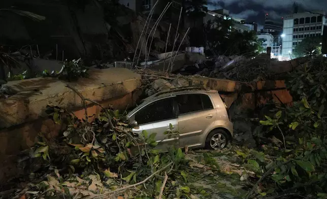 A car smashed by a collapsed building after an earthquake in Caracas, Venezuela, Wednesday, June 24, 2026. (AP Photo/Adrian Naranjo)
