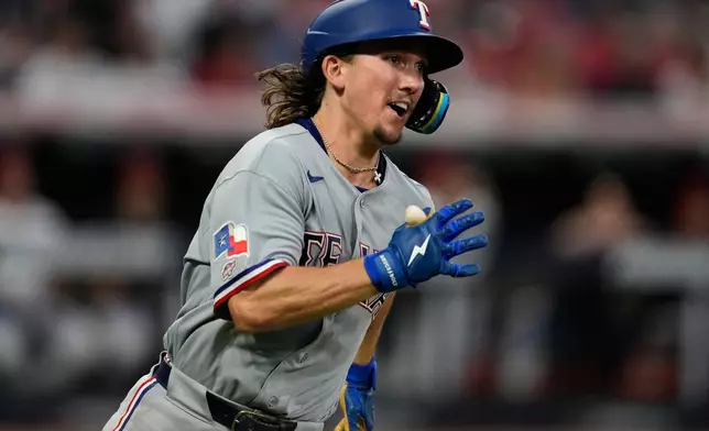 Texas Rangers' Cameron Cauley runs towards first base with a triple, his first major league hit, in the seventh inning of a baseball game against the Cleveland Guardians in Cleveland, Monday, June 29, 2026. (AP Photo/Sue Ogrocki)