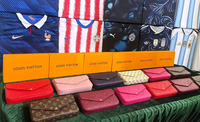 Handbags are showcased by Hong Kong customs authorities in a new conference about counterfeit and infringing goods at their headquarters in North Point, Hong Kong Thursday, June 11, 2026. (AP Photo/Kanis Leung)